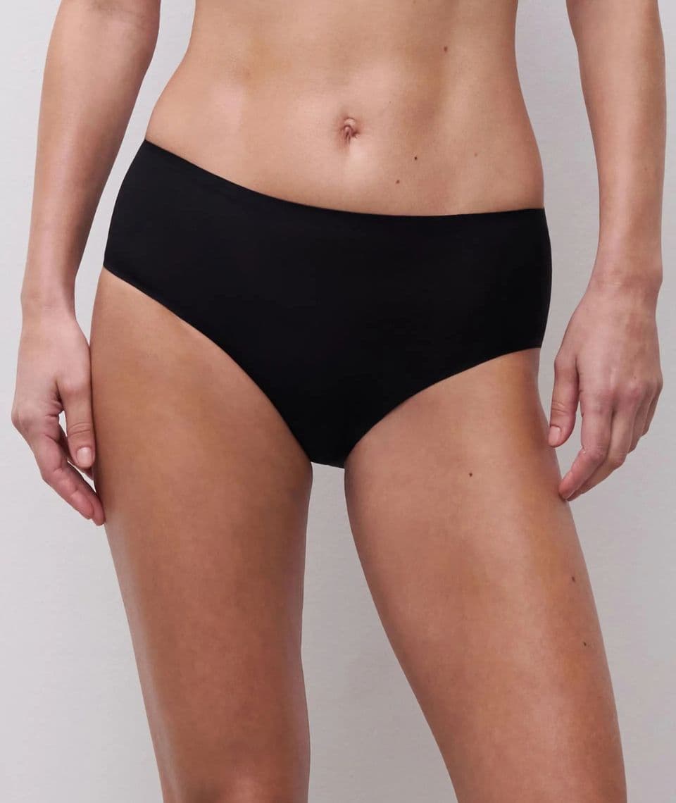 Person wearing plain black high-waisted underwear against a neutral background. Their midriff, waist, and thighs are visible.